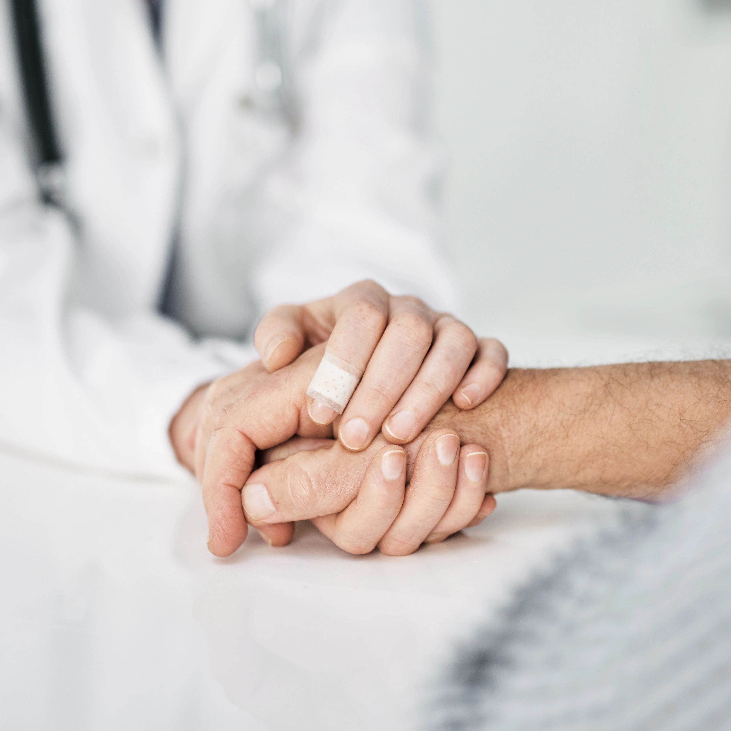 Doctor consoling a patient during a clinic visit