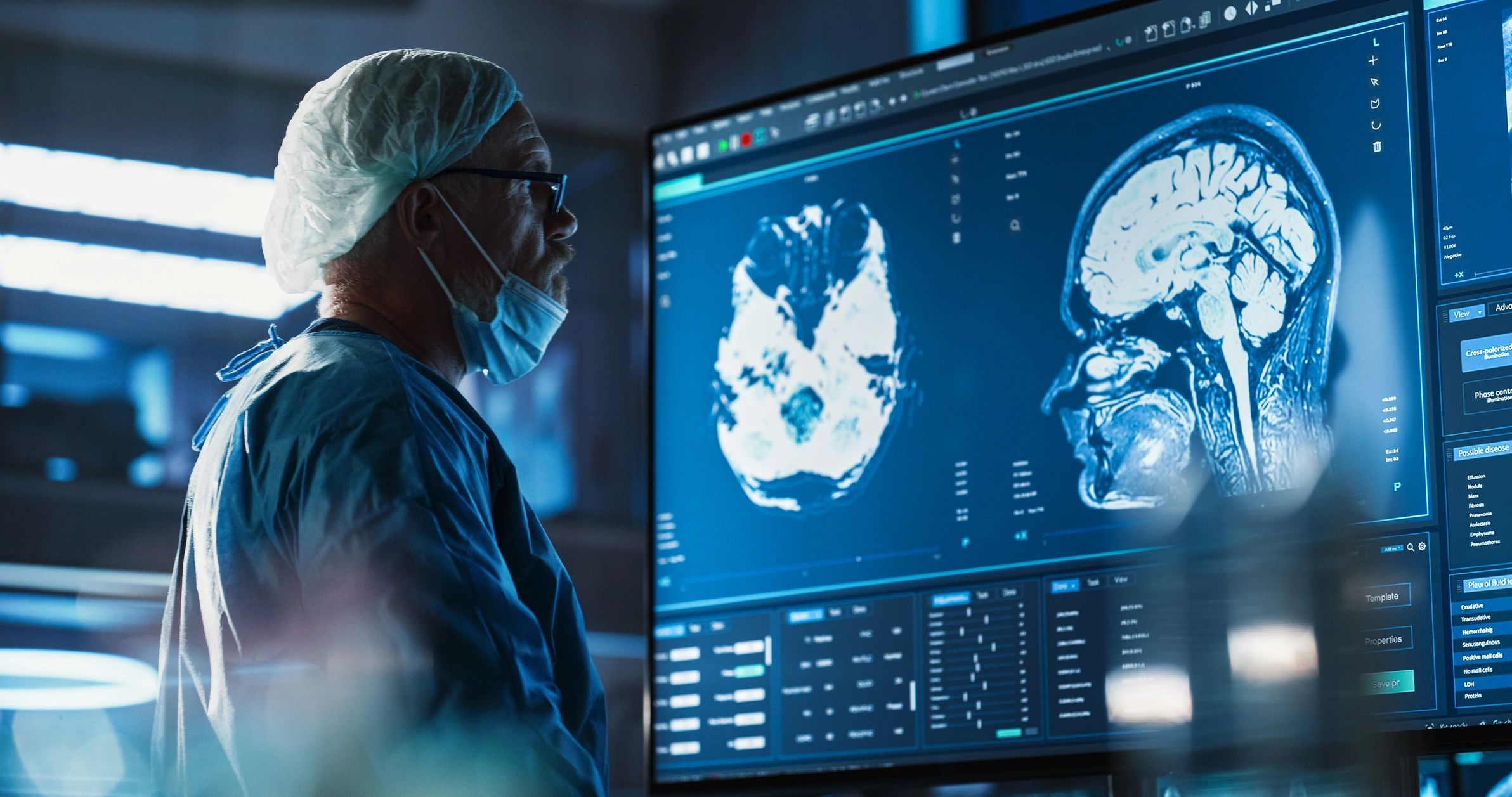 Neurosurgeon reviewing brain MRI scans on a monitor
