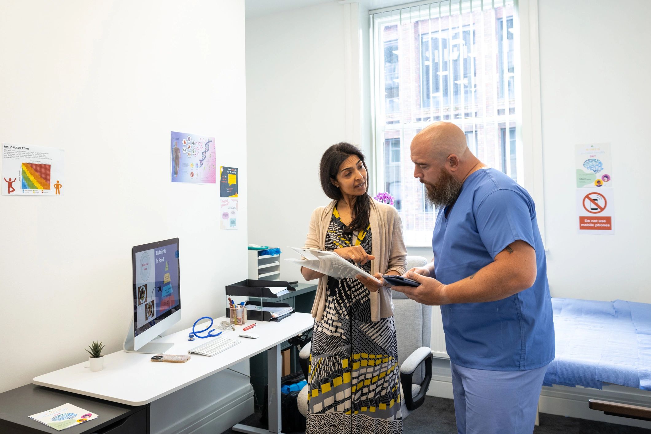 Clinician reviewing notes in a consultation room